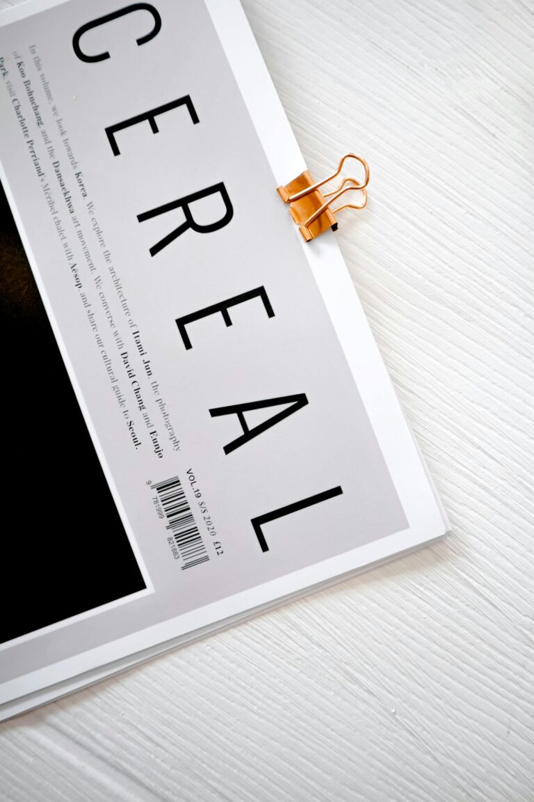 Stylish magazine cover featuring a bold CEREAL title clipped with a gold binder on white background.