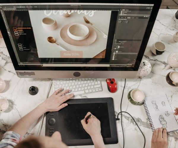 Overhead view of a creative workspace with design tools and sketches visible, ideal for teamwork and collaboration.